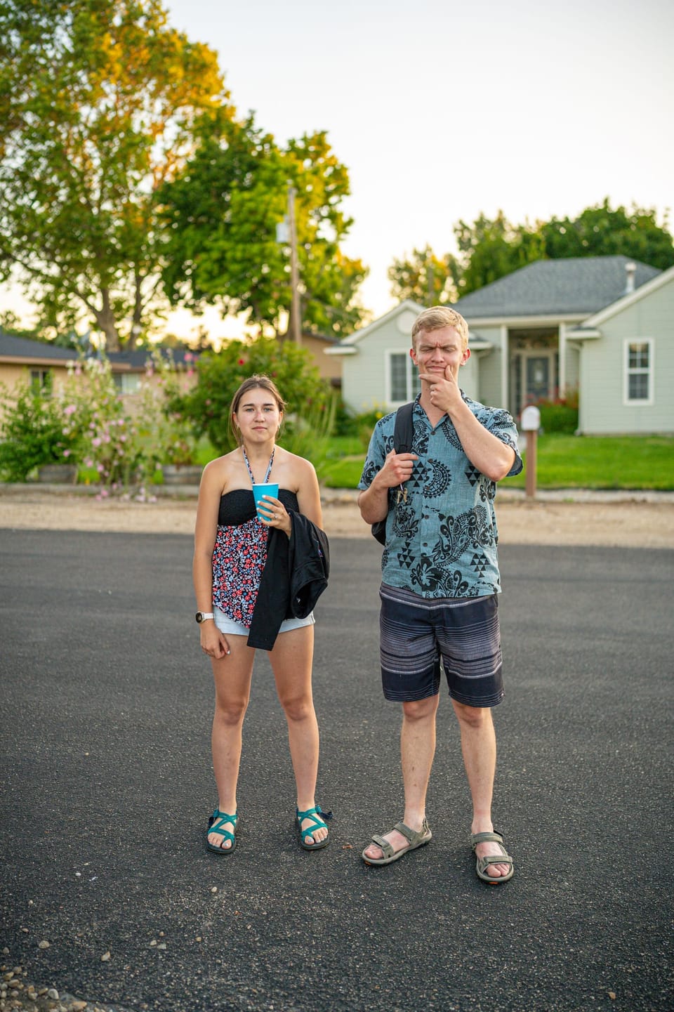 Group of friends standing together in a quiet street on a summer evening