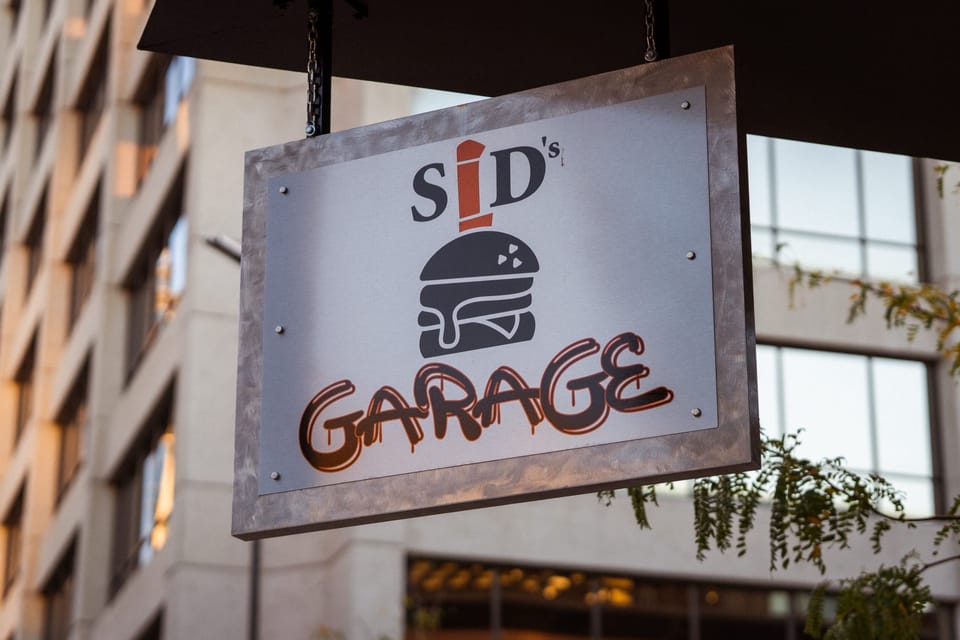 Hanging restaurant sign on a downtown building