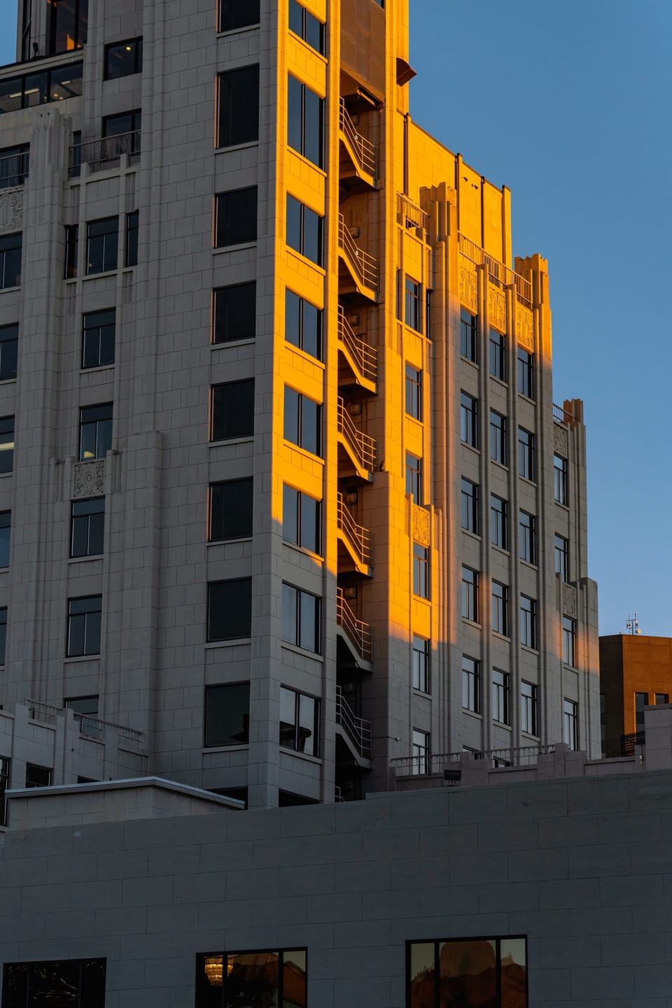 Tall apartment building catching golden evening light