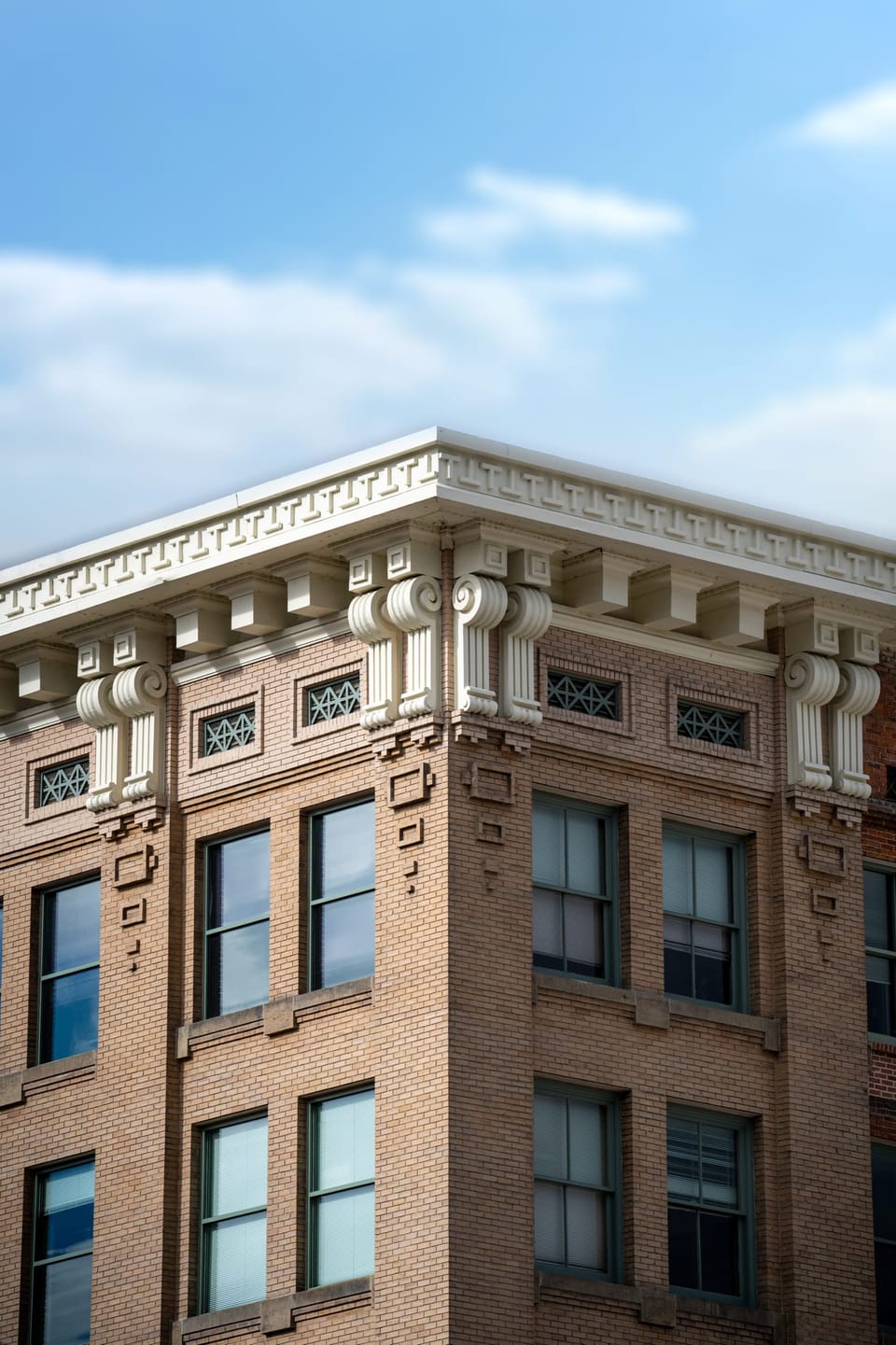 Historic brick building with an ornate cornice against a blue sky