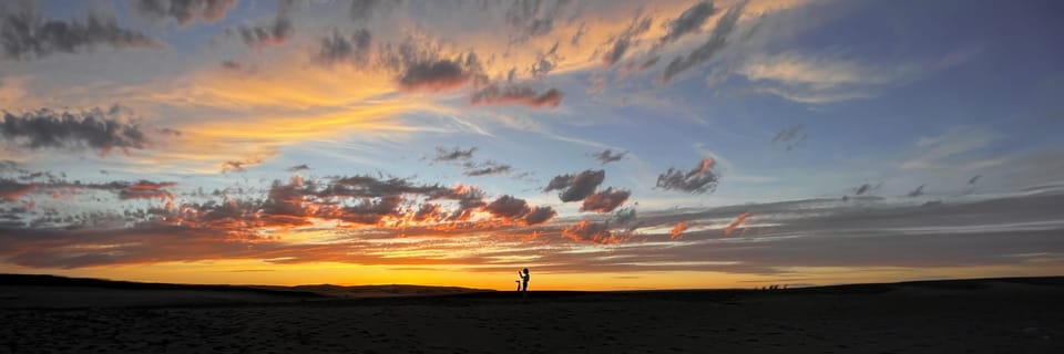 Panorama of a fiery sunset over a dark horizon