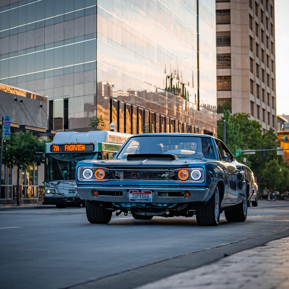 Blue lifted Dodge truck on a downtown street