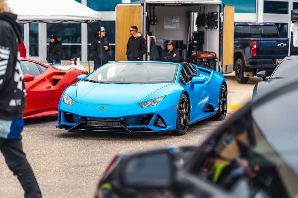 Blue Lamborghini among show-goers at a car meet