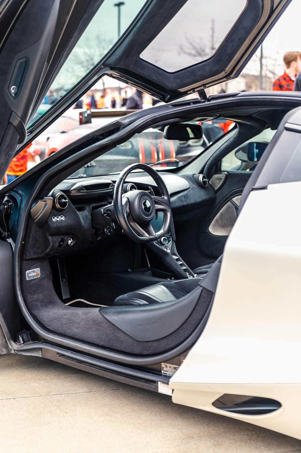 White McLaren with its dihedral door open