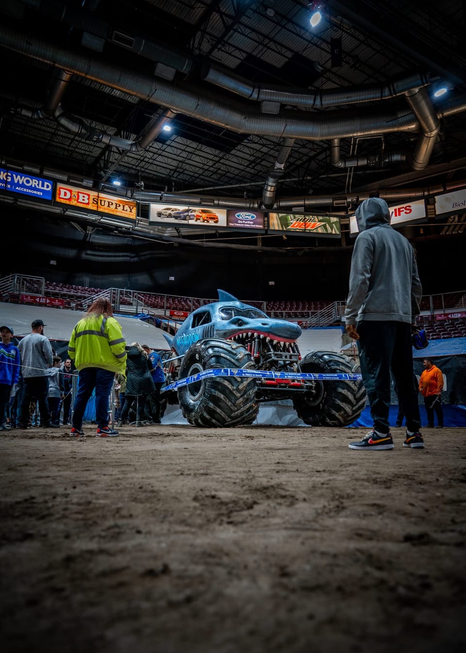 Monster truck and crew in a stadium arena