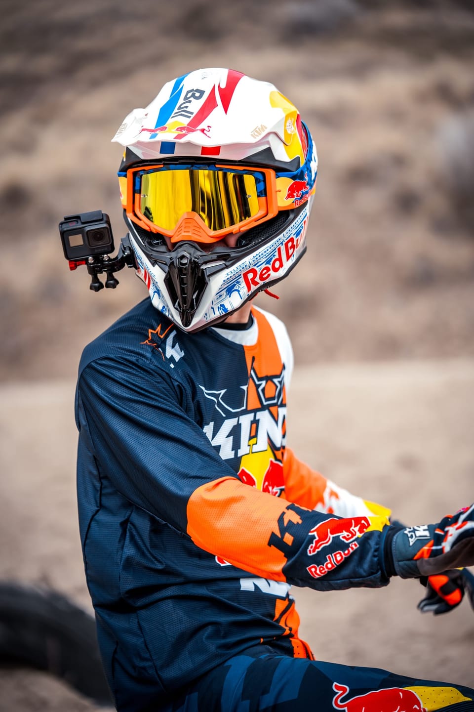 Motocross rider in full gear gripping the handlebars